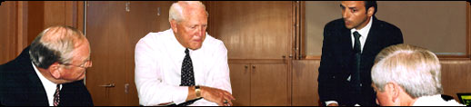 Photo of Bo Schembechler, Bill Walsh and author Robert Evangelista consulting with a Fortune 50 Chairman/CEO on team building and performance improvement coaching. 